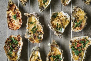 Cooling Rack With Tasty Baked Oysters On Grey Background