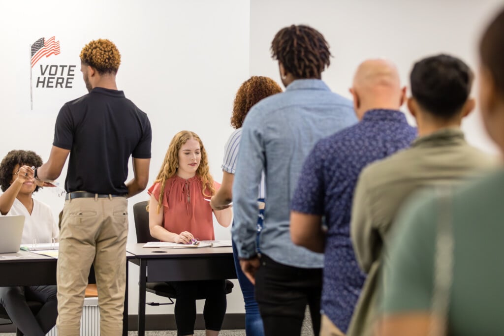 Rear View Long Line Of People Waiting For Voting Ballots from Getty Images