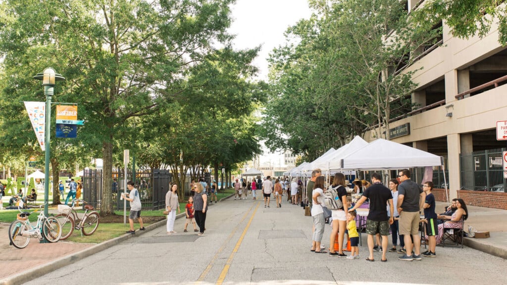 Downtown Lafayette's Monthly ArtWalk. Open street in Downtown Lafayette with tents and people.