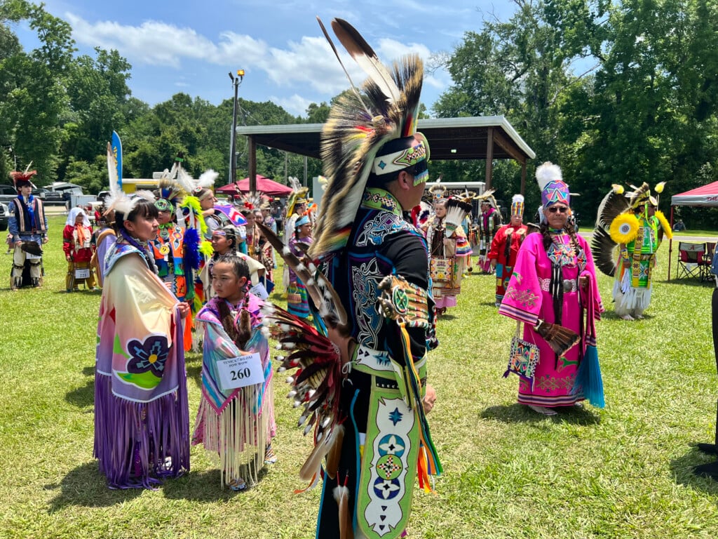 Image from Tunica-Biloxi Pow Wow in an open field with people