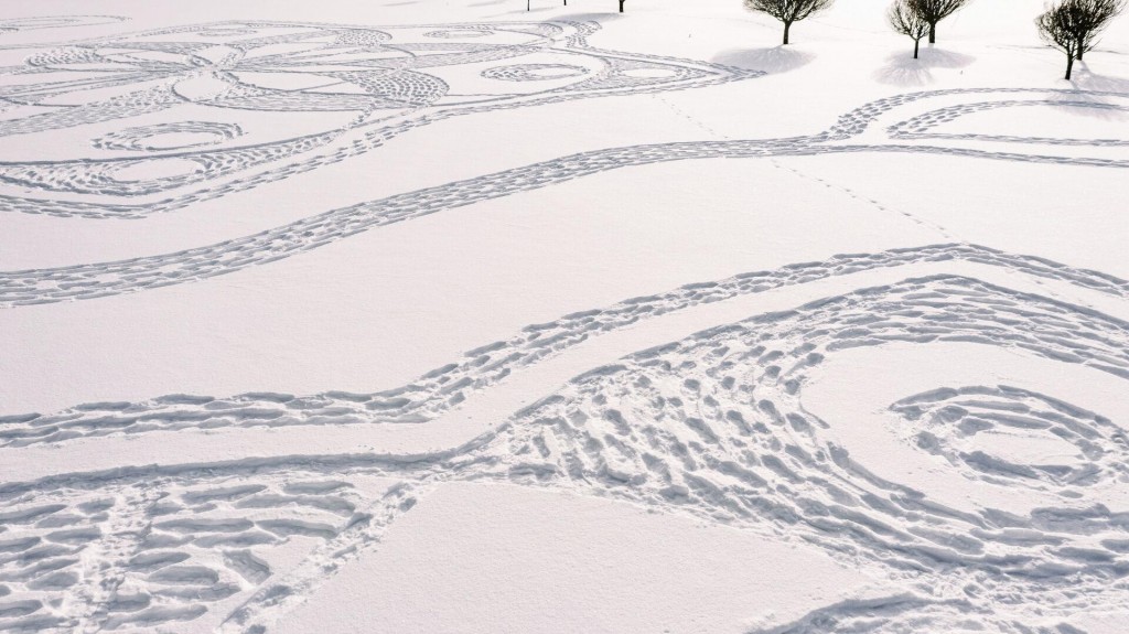 Finns In Snowshoes Create Temporary Artwork On Golf Course