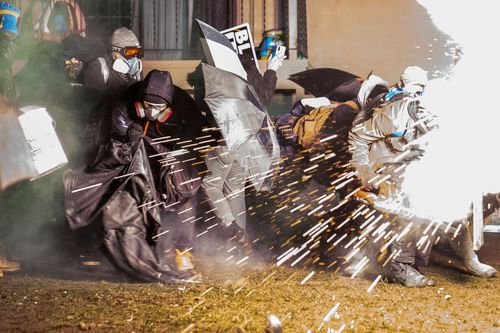 Protesters And Police Clash For A Third Night In A Minneapolis Suburb As Prosecutors Weigh Charges Against Officer