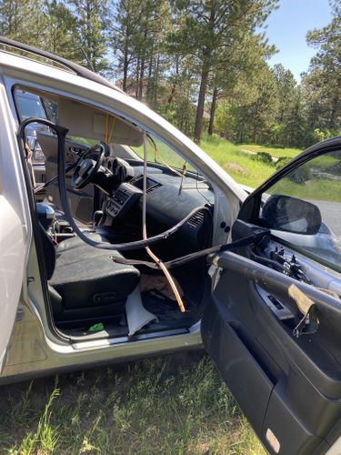 Bear Smells Case Of Beer In Car, Locks Itself Inside & Leaves Damage Behind