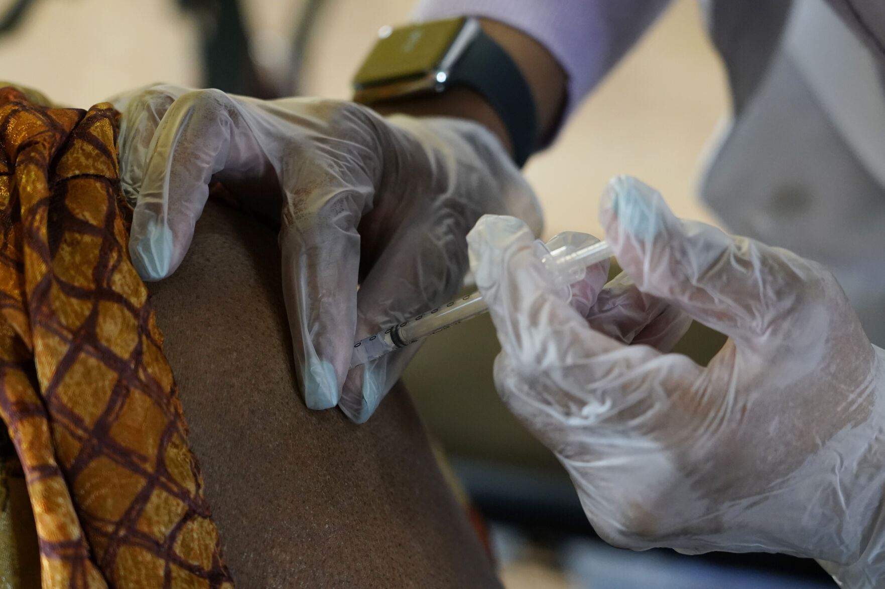<p>A resident of Harmony Court Assisted Living receives the Pfizer COVID-19 vaccine in Jackson, Miss.</p>