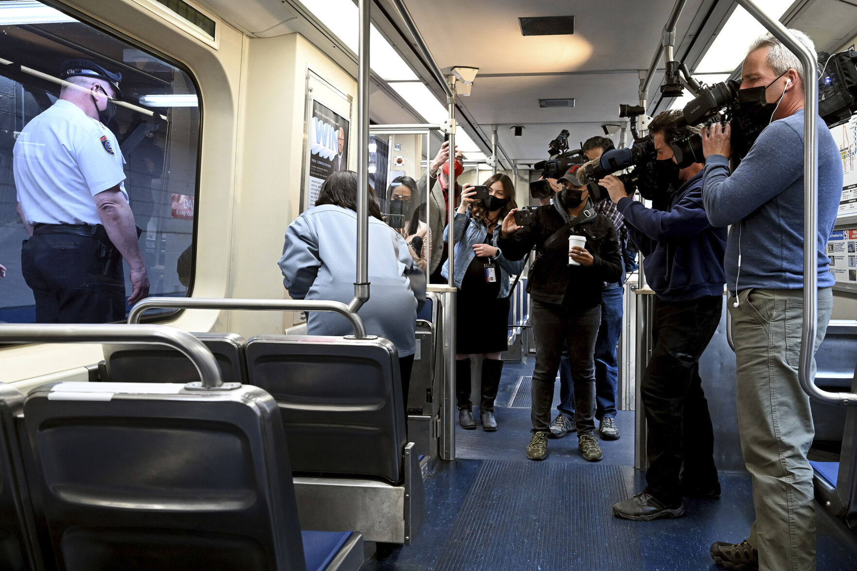 <p>SEPTA Transit Police Chief Thomas Nestel III, seen through window at left, stands by following a news conference on an El platform at the 69th Street Transportation Center Monday in Philadelphia, following a brutal rape on the El over the weekend. SEPTA subway elevated Chief Officer Chrystalle Hooper, center, demonstrates the emergency call boxes on SEPTA trains and how to properly contact police from their cars.</p>