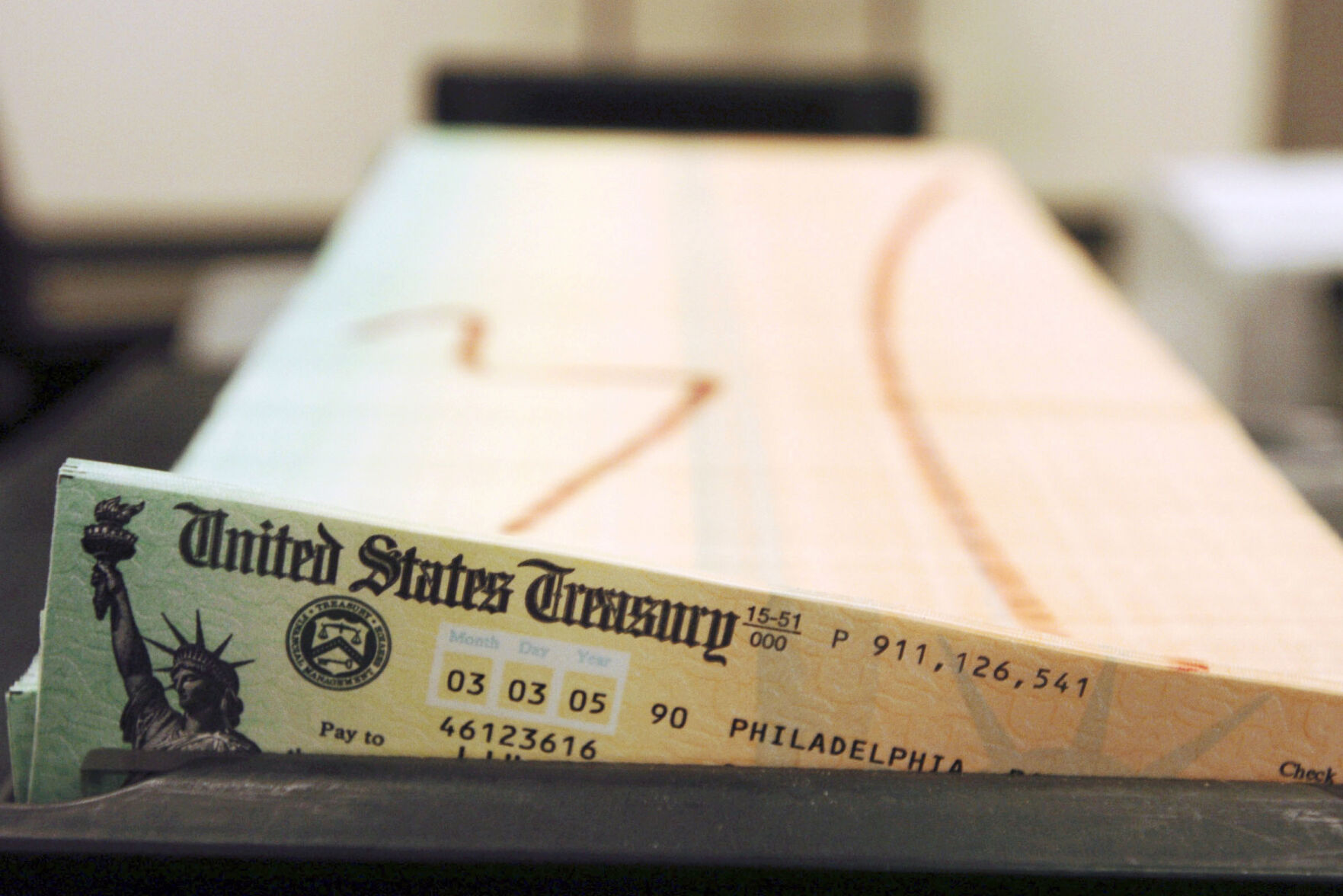 <p>FILE - Trays of printed social security checks wait to be mailed from the U.S. Treasury's Financial Management services facility in Philadelphia on Feb. 11, 2005. On Friday, Oct. 29, 2021, The Associated Press reported on stories circulating online incorrectly claiming refugees resettled in the U.S. receive ,125 per month from the government, while Social Security recipients only receive an average of ,400 per month. Refugees receive no such monthly payment. (AP Photo/Bradley C. Bower, File)</p>