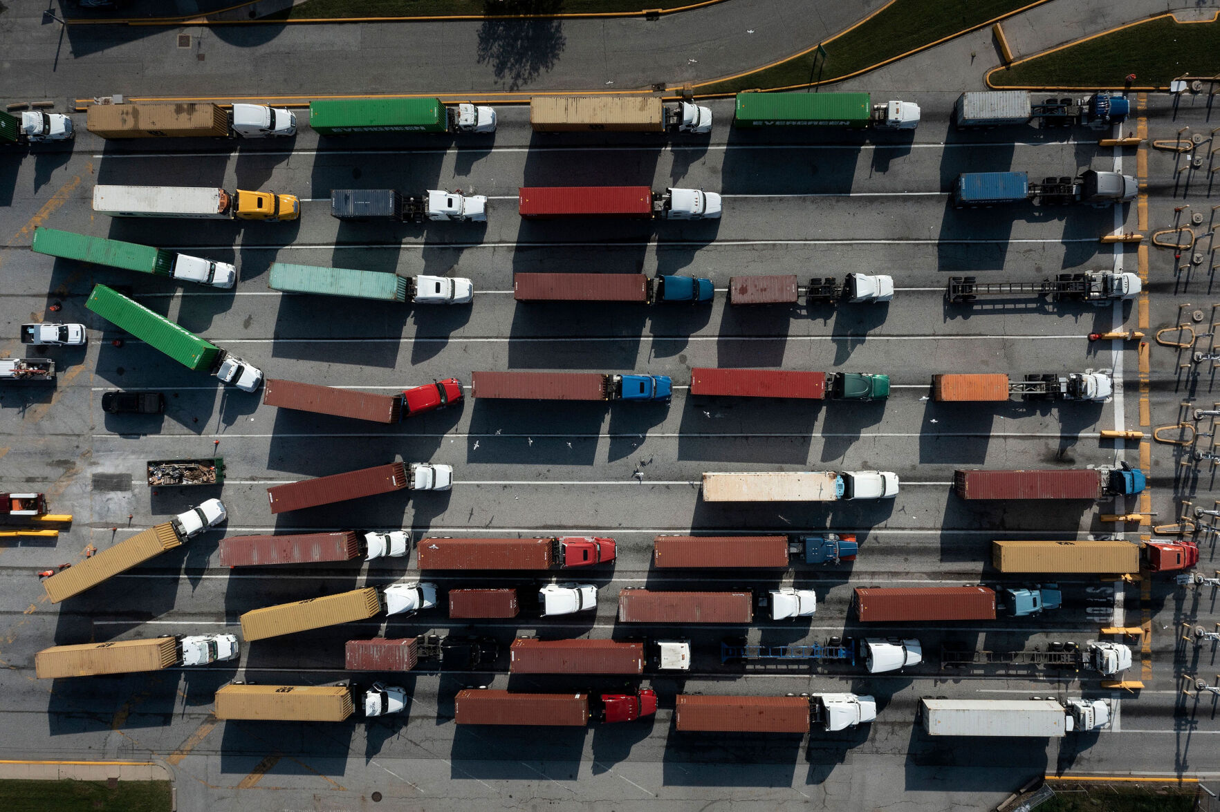 <p>Trucks transport cargo containers, but truckers are hard to come by.</p>