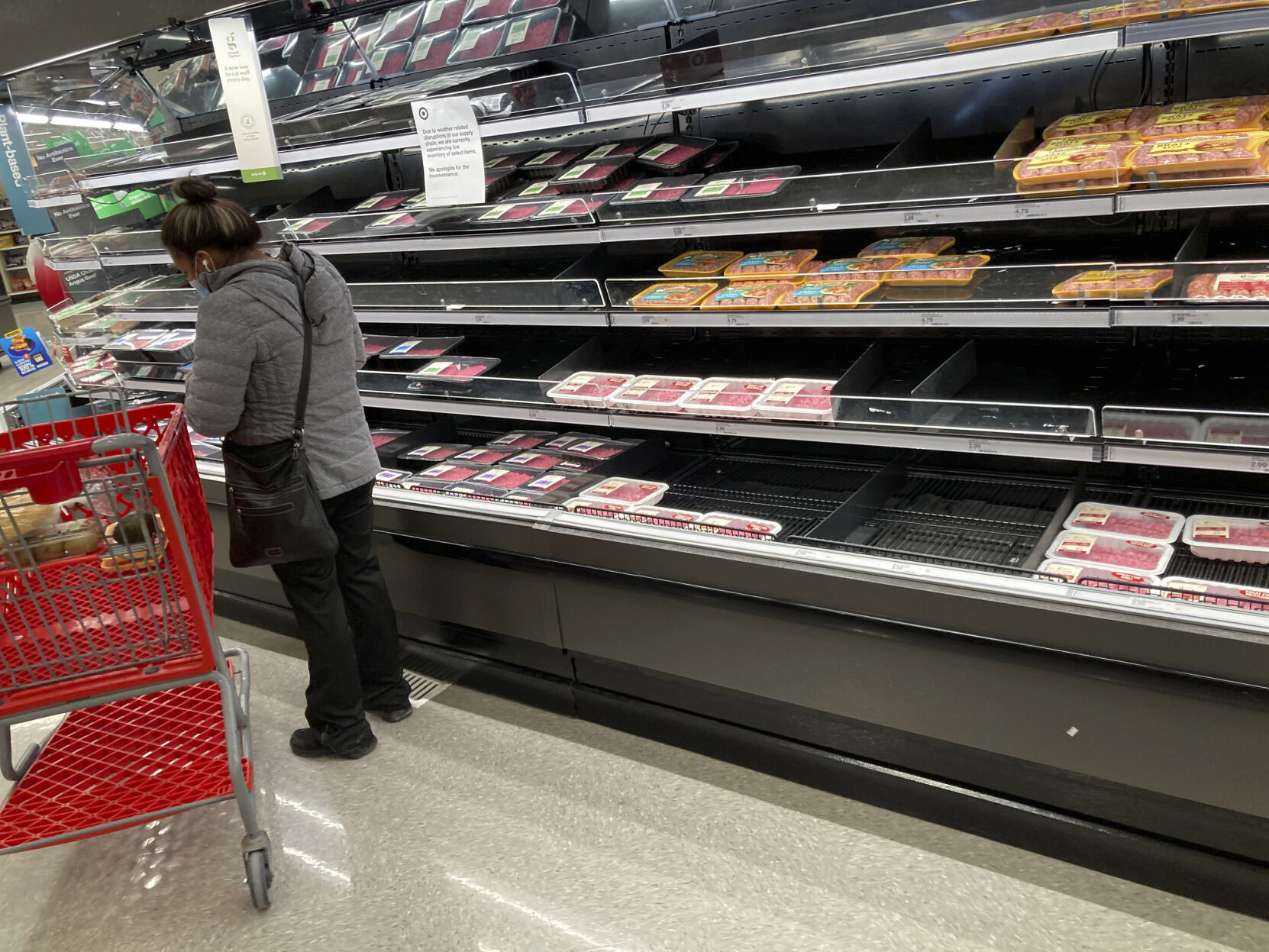 <p>Signs advise consumers of weather-related shortages of goods on the shelves of a meat case in a grocery store Sunday, Feb. 21, 2021, in Highlands Ranch, Colo. (AP Photo/David Zalubowski)</p>