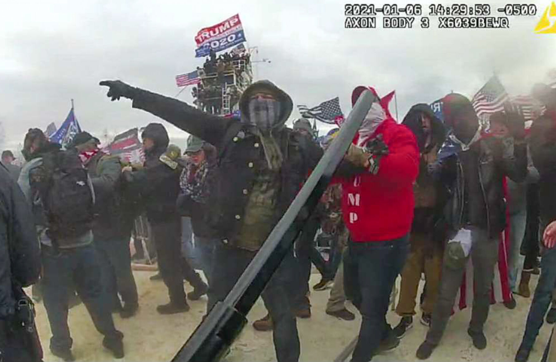 <p>This image, from a criminal complaint, shows Brian Christopher Mock, center, in an image captured in police body-worn video on the West Front of the U.S. Capitol in Washington, on Jan. 6, 2021.</p>