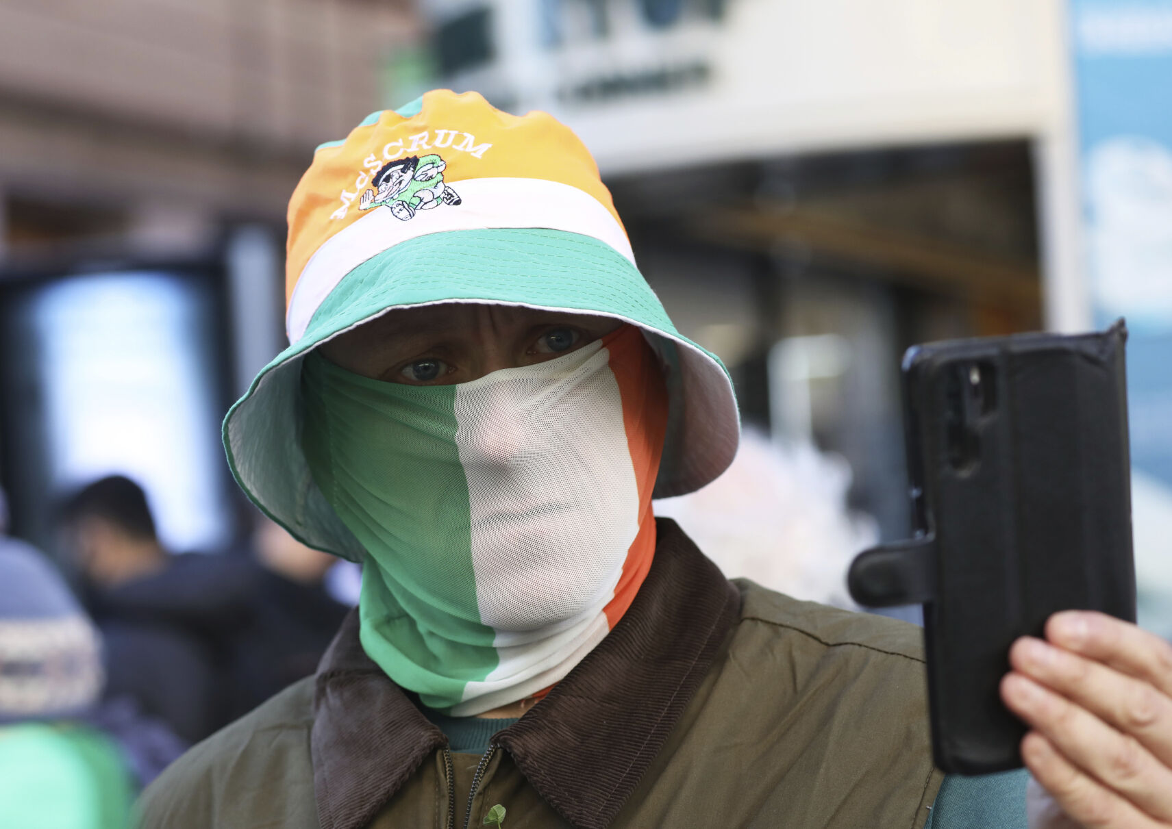 <p>An anti lockdown protester films the media during a rally in Dublin, Ireland, Wednesday, March, 17, 2021. St Patrick's Day celebrations have been cancelled for the second year in a row due to the COVID-19 crisis. (AP Photo/Peter Morrison)</p>