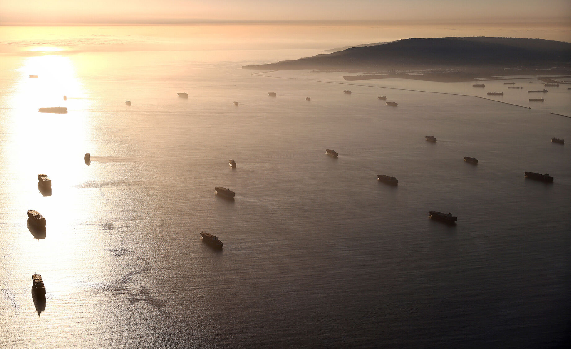 <p>Container ships are anchored by the ports of Long Beach and Los Angeles as they wait to offload.</p>