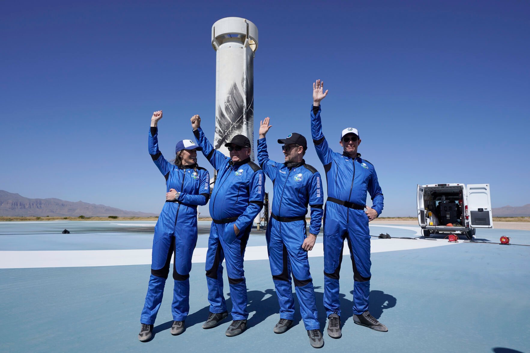 <p>Blue Origin's New Shepard rocket latest space passengers, from left, Audrey Powers, William Shatner, Chris Boshuizen, and Glen de Vries raise their hands during a media availability at the spaceport near Van Horn, Texas, on Oct. 13, 2021..</p>