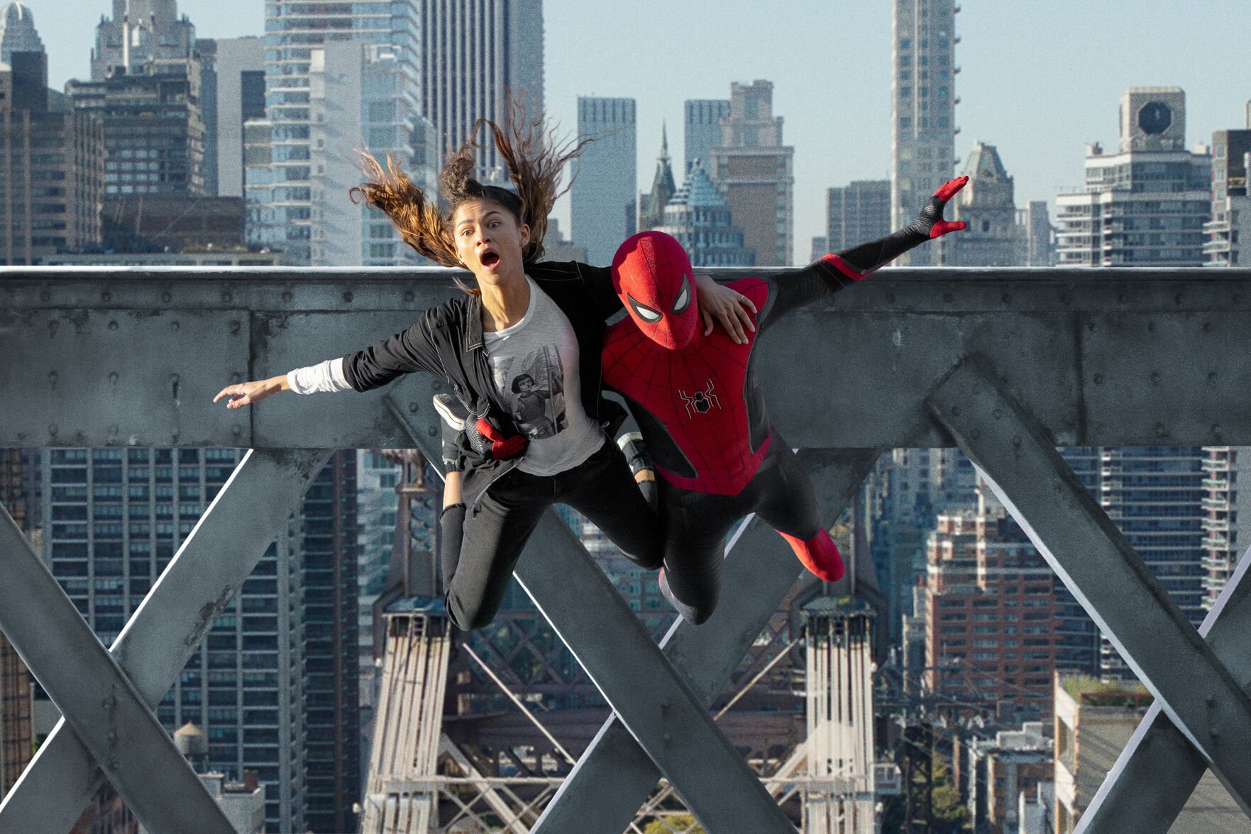 <p>MJ (Zendaya) and Spider-Man (Tom Holland) jump off a bridge in "Spider-Man: No Way Home." (Matt Kennedy/Sony Pictures/TNS)</p>
