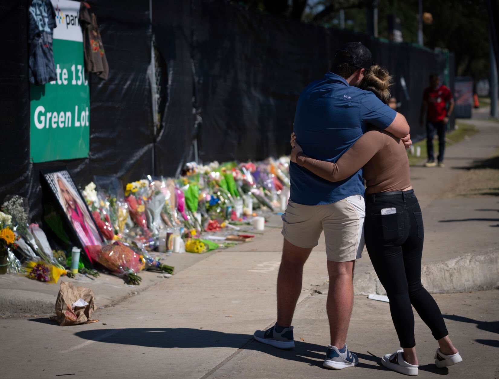 <p>Two people who knew an unidentified victim at the Houston Astroworld concert embrace at a memorial on Sunday.</p>