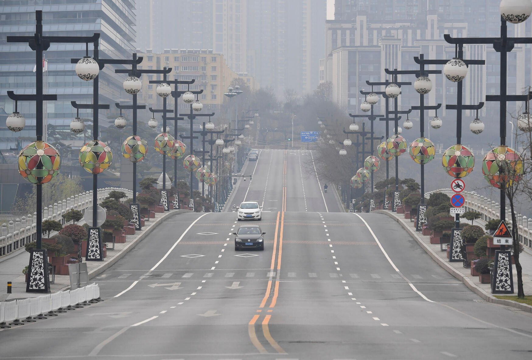 <p>In this photo released by China's Xinhua News Agency, cars drive down a nearly empty street in Xi'an in northwestern China's Shaanxi Province, Thursday, Dec. 23, 2021. </p>