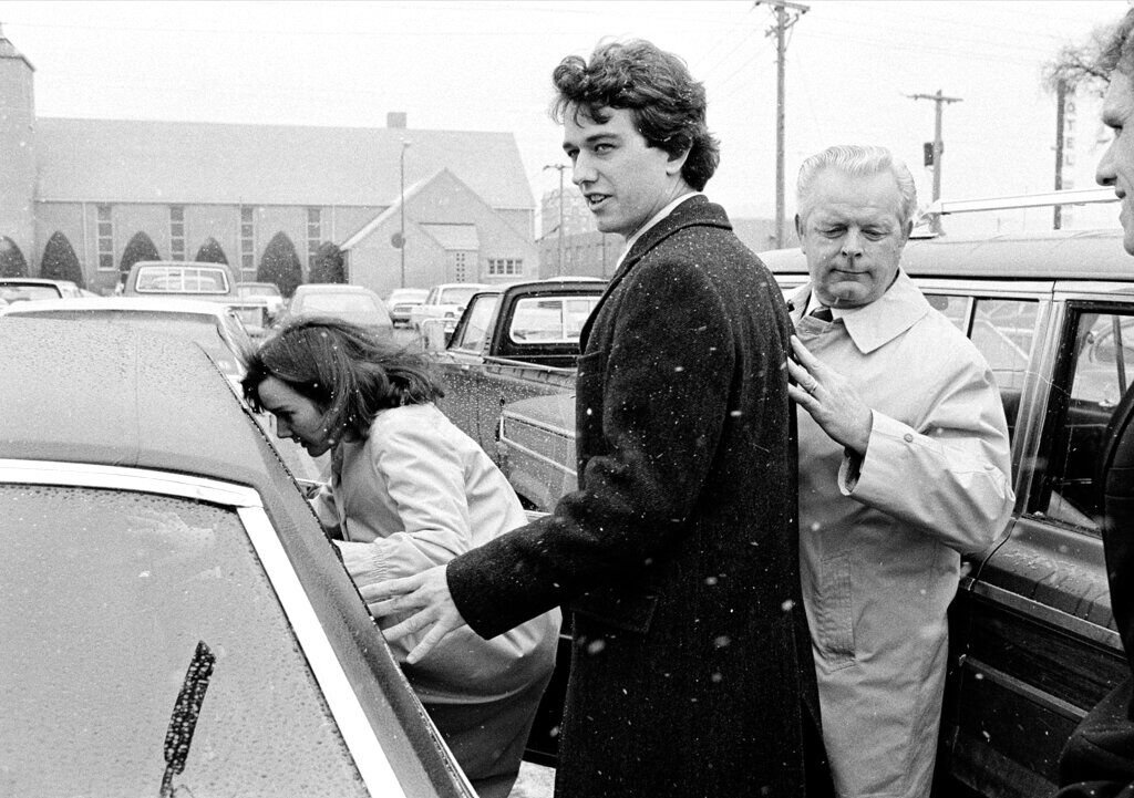 <p>FILE - In this March 17, 1984 file photo, Robert Kennedy Jr. and his wife, Emily, get into a car as they are escorted by private investigator Don Wiley outside the courthouse in Rapid City, S.D</p>