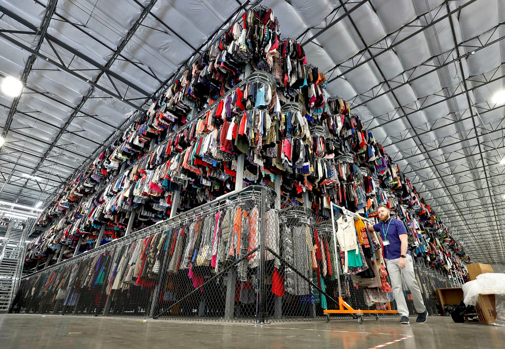 <p>FILE - Thousands of garments are stored on a three-tiered conveyor system at the ThredUp sorting facility in Phoenix on March 12, 2019. Resale has taken off among some looking to save the planet and spend less on gifts during the most wasteful time of the year _ the December holidays. This year’s supply chain delays have provided extra motivation. (AP Photo/Matt York, File)</p>