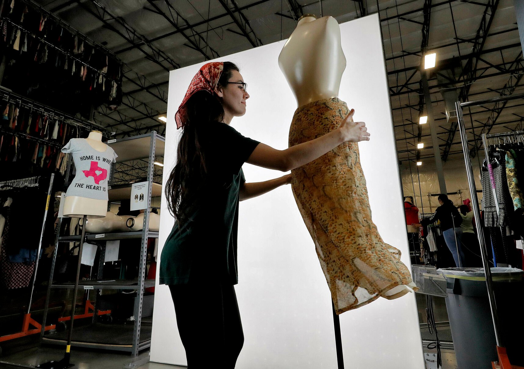 <p>FILE - Samantha Estes prepares garments to be photographed at the ThredUp sorting facility in Phoenix on March 12, 2019. Resale has taken off among some looking to save the planet and spend less on gifts during the most wasteful time of the year _ the December holidays. This year's supply chain delays have provided extra motivation. (AP Photo/Matt York, File)</p>