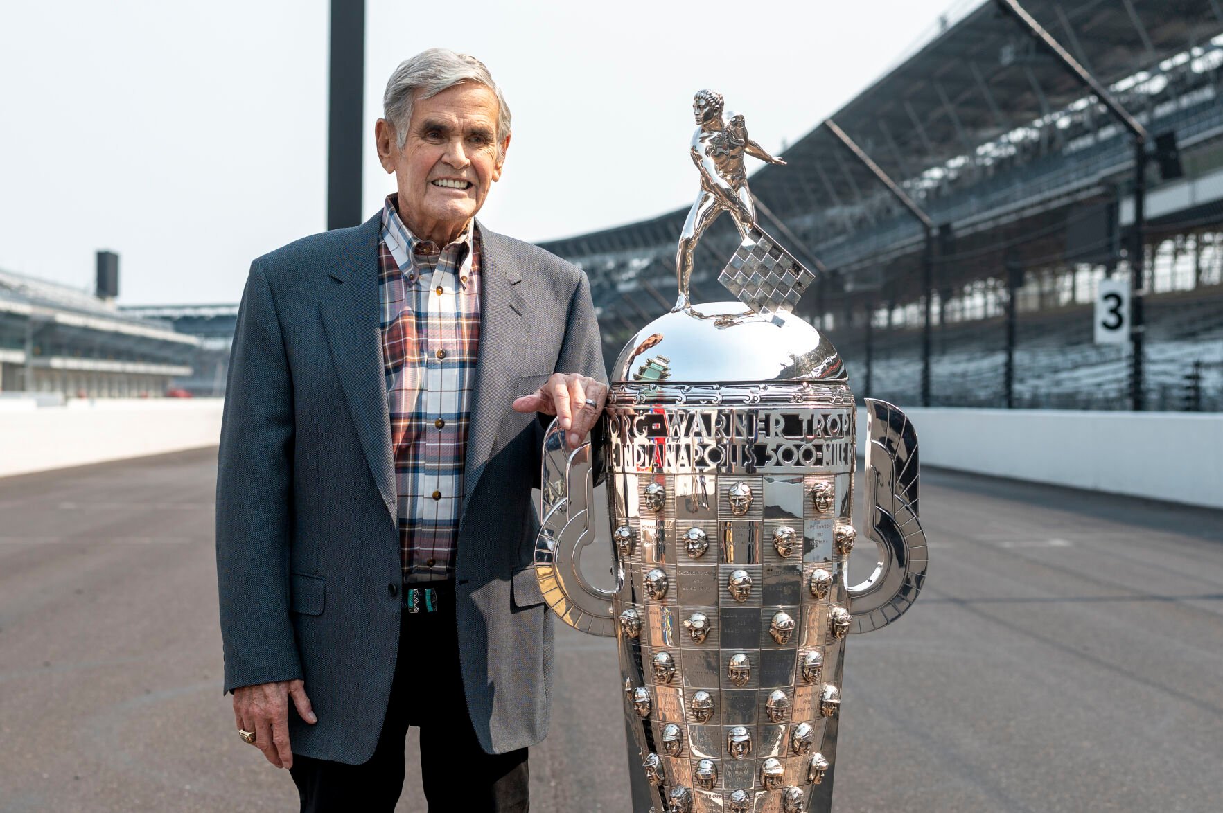 <p>FILE - Four-time winner of the Indianapolis 500, Al Unser, poses with the Borg-Warner Trophy at the Indianapolis Motor Speedway in Indianapolis, Tuesday, July 20, 2021. </p>