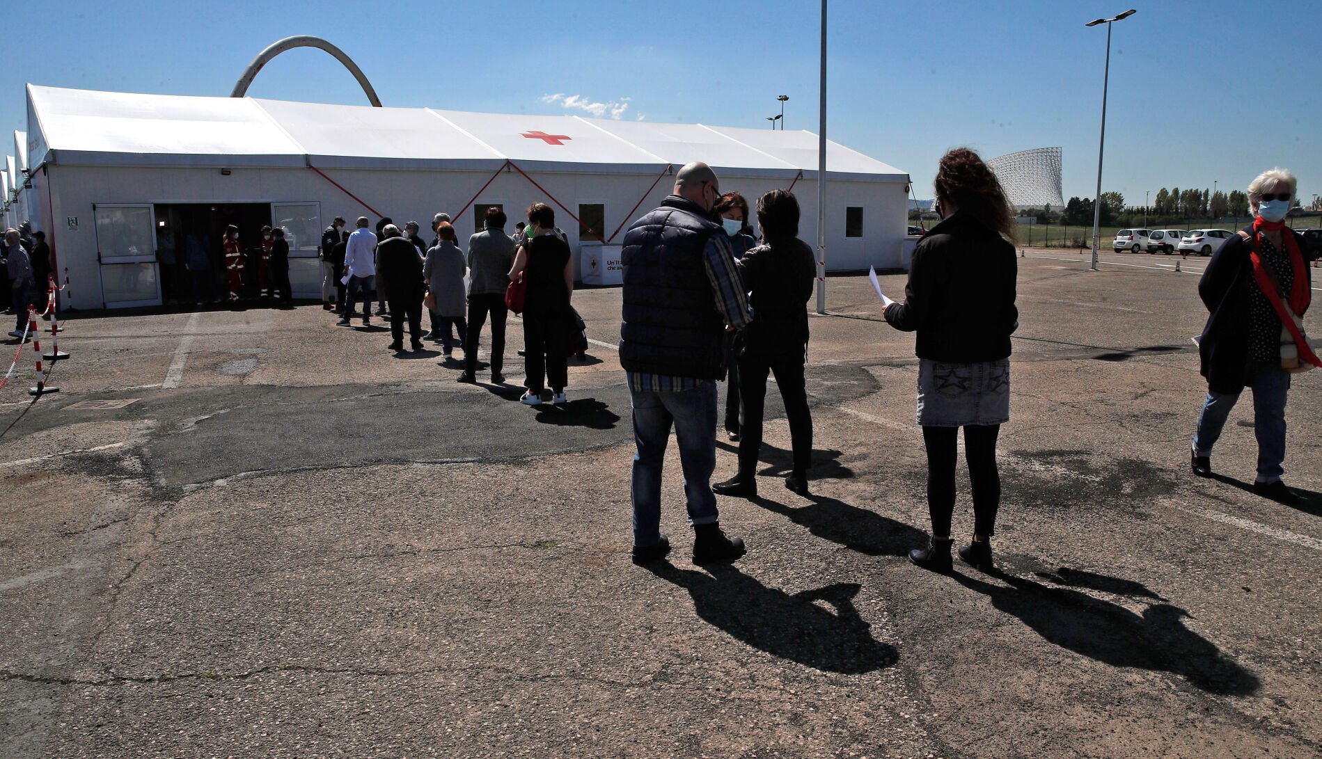 <p>People wait in line at a COVID-19 vaccination center near a hospital in Rome on April 24, 2021.</p>