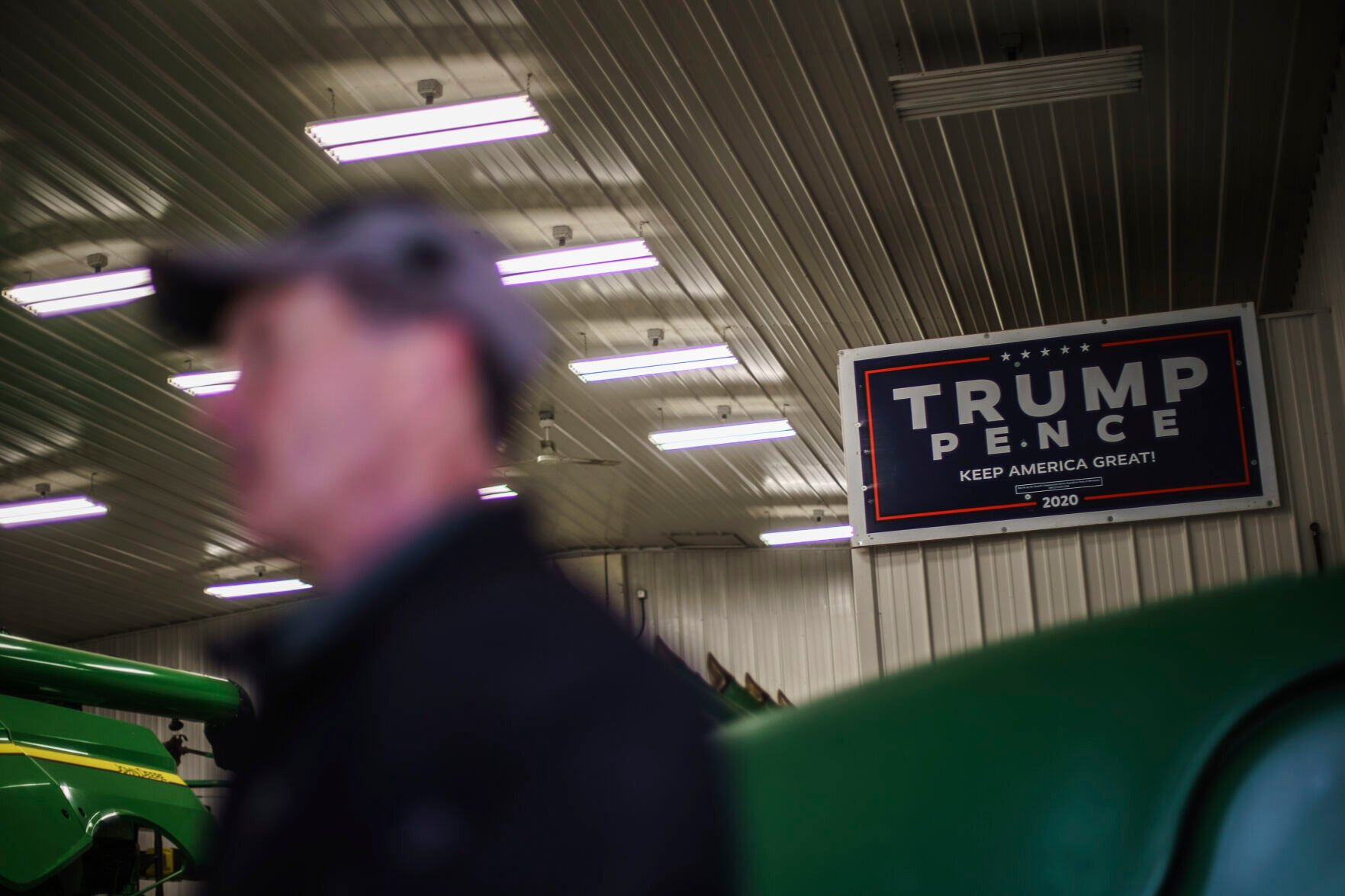 <p>Al Saunders stands beneath a Trump campaign sign in his farm's tool shed in Benson, Minn., Wednesday, Dec. 1, 2021. Trump's cries that he loved America resonated in an area where new approaches to teaching U.S. history, with an increased focus on race, were confounding. </p>