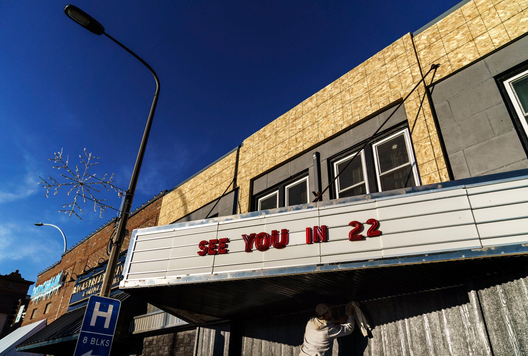 <p>A worker polishes a marquee at a theater under renovation in Benson, Minn., Monday, Nov. 29, 2021. It can be easy, looking around Benson, to think it is a land that time forgot. </p>