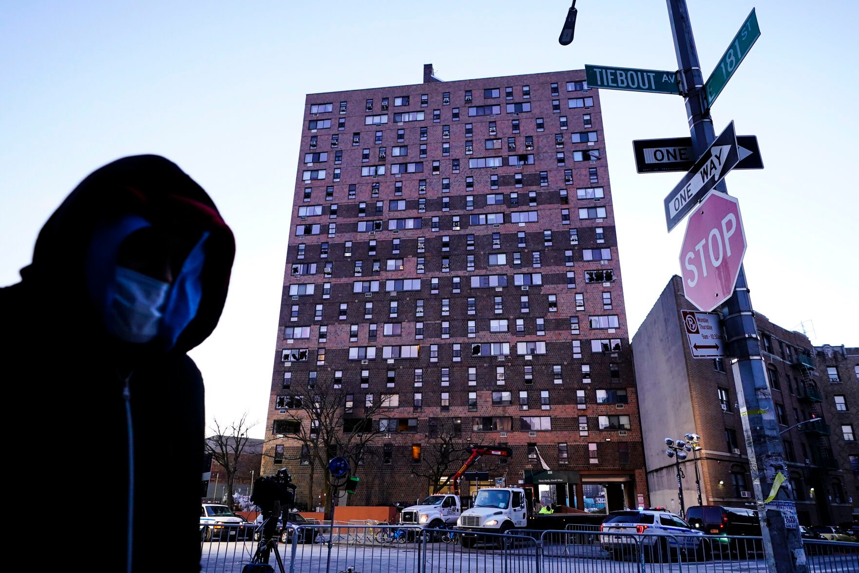 <p>A person walks past an apartment building which suffered the city's deadliest fire in three decades, in the Bronx borough of New York, Tuesday, Jan. 11, 2022. </p>