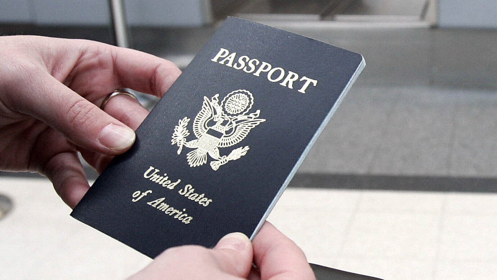 <p>A passenger waits in line with her passport 23 January, 2007 before her Mexicana Air flight out of Chicago O'Hare International airport in Chicago, Illinois.</p>