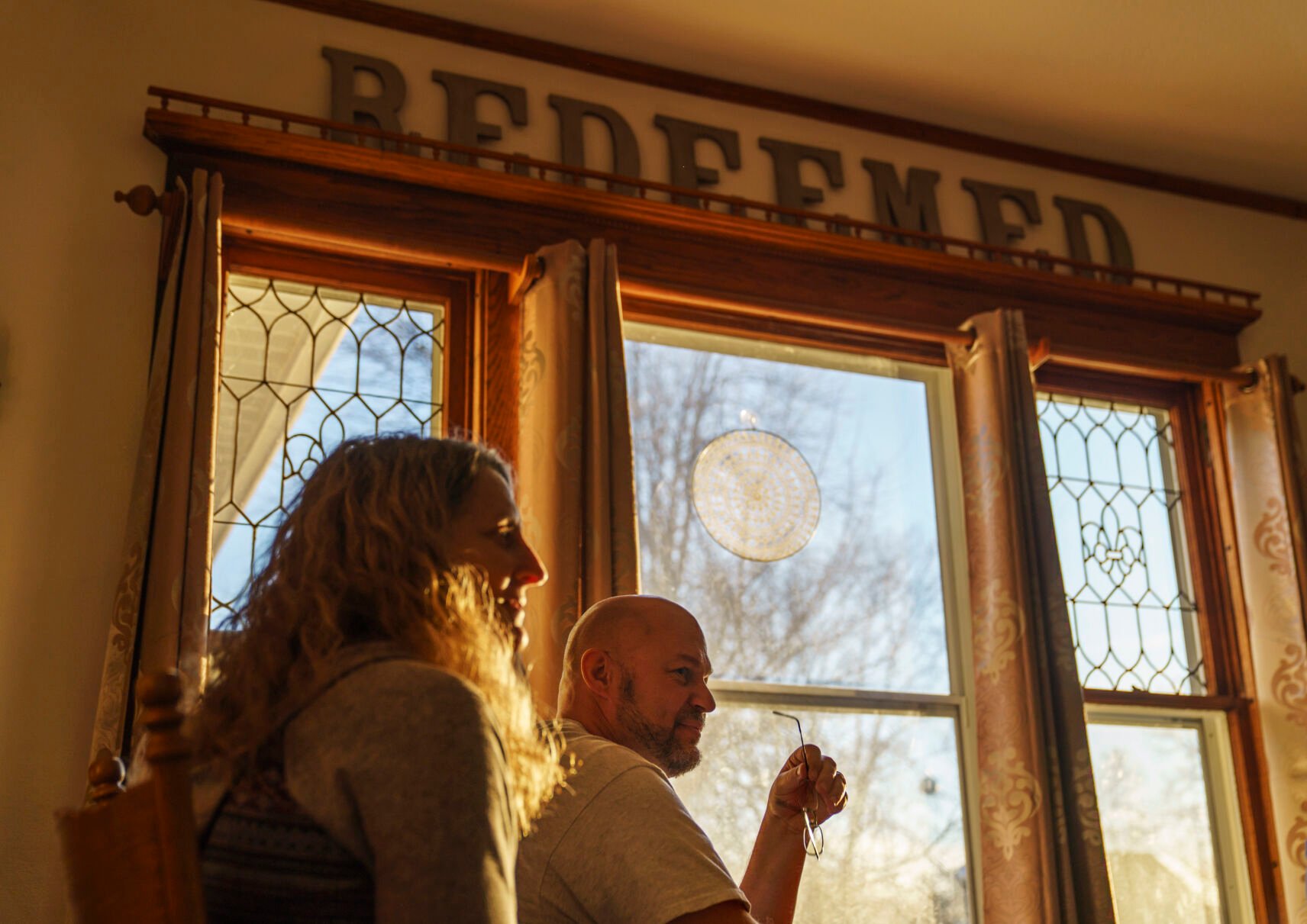 <p>Jason Wolter right, pastor of St. Mark's Lutheran Church, sits next to his wife, Tracy, at their home in Benson, Minn., Monday, Nov. 29, 2021. </p>