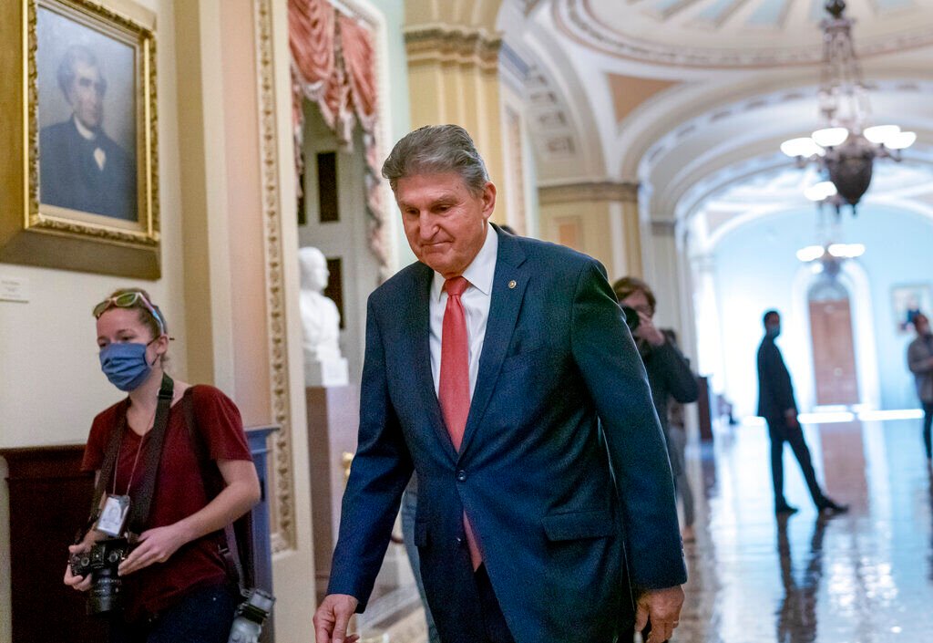 <p>Sen. Joe Manchin, D-W.Va., a centrist Democrat vital to the fate of President Joe Biden's .5 government overhaul, walks to a caucus lunch at the Capitol in Washington, Friday, Dec. 17, 2021. </p>