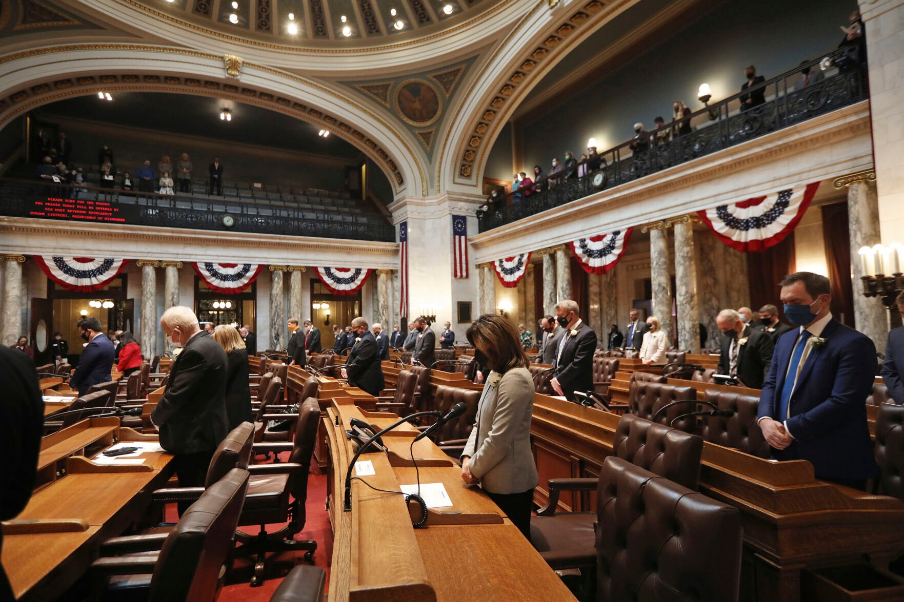 <p>In this Jan. 4, 2021, photo, members of the state Assembly rise for prayer during the first 2021-22 legislative session in the Assembly Chambers at the Wisconsin State Capitol in Madison, Wis.</p>
