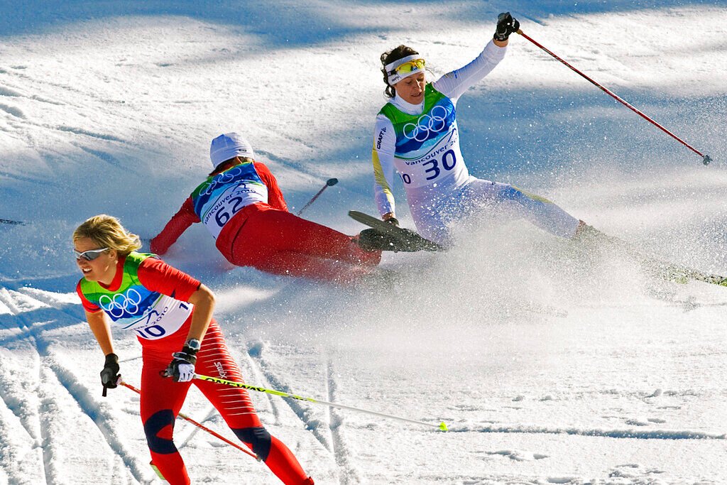 <p>FILE - Norway's Vibeke Skofterud, left, escapes a crash involving Sweden's Norgren Johansson, right, and Poland's Paulina Maciuszek in the women's 15-kilometer pursuit cross country skiing event at Whistler Olympic Park on February 19, 2010, at the 2010 Vancouver Olympic Winter Games in Whistler, B.C. Many top Nordic skiers and biathletes say crashes are becoming more common as climate change reduces the availability of natural snow, forcing racers to compete on tracks with the manmade version. (AP Photo/Andrew Vaughan, CP, File)</p>