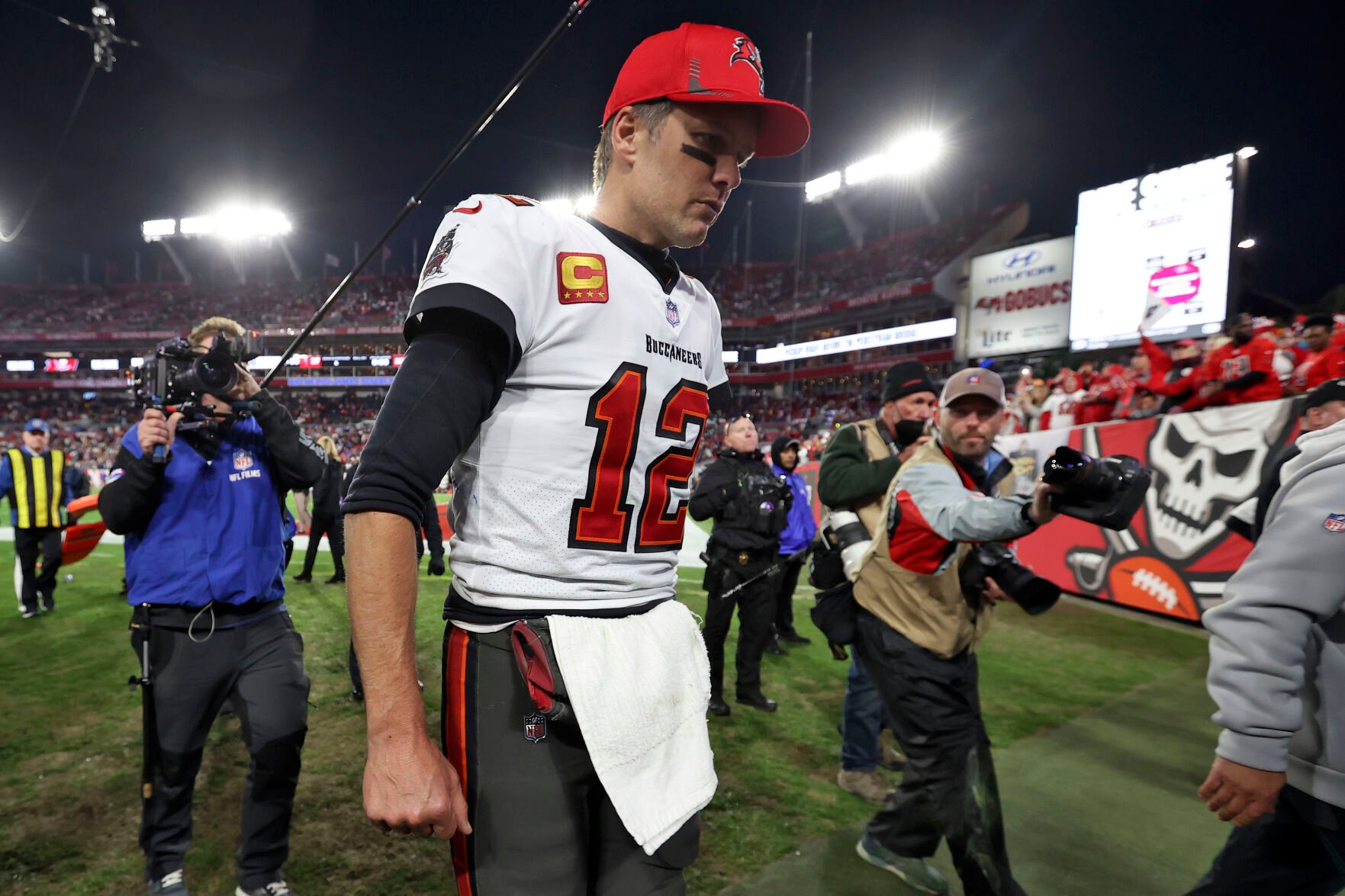 <p>Tampa Bay Buccaneers quarterback Tom Brady (12) reacts as he leaves the field after the team lost to the Los Angeles Rams during an NFL divisional round playoff football game Sunday, Jan. 23, 2022, in Tampa, Fla. </p>
