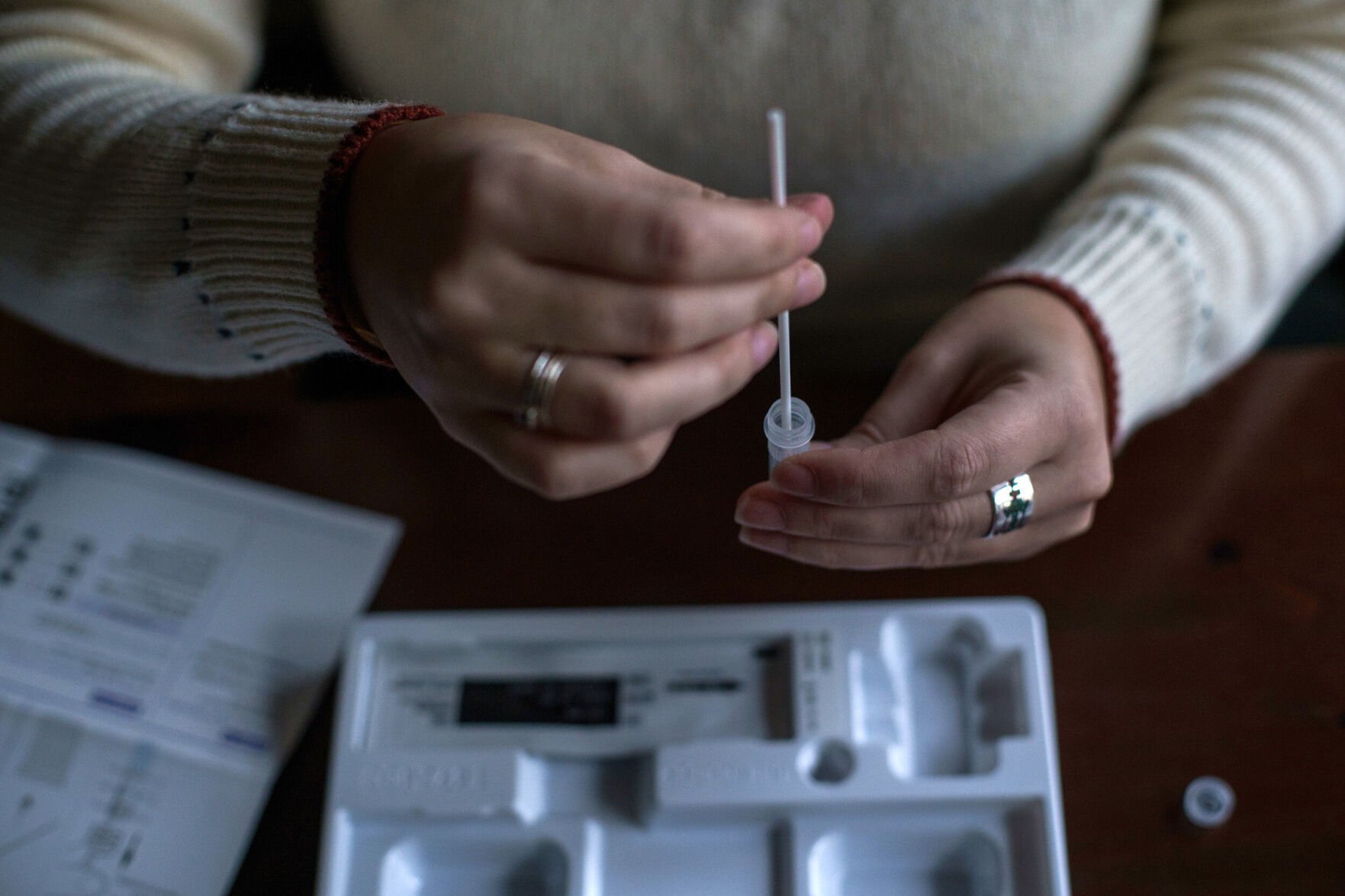 <p>The new government website where people can order free Covid-19 at-home rapid antigen tests is up and running, and pictured, a resident processes a self-administered at-home Covid-19 test, received through a government program, in New Hampshire, on December 7, 2021.</p>