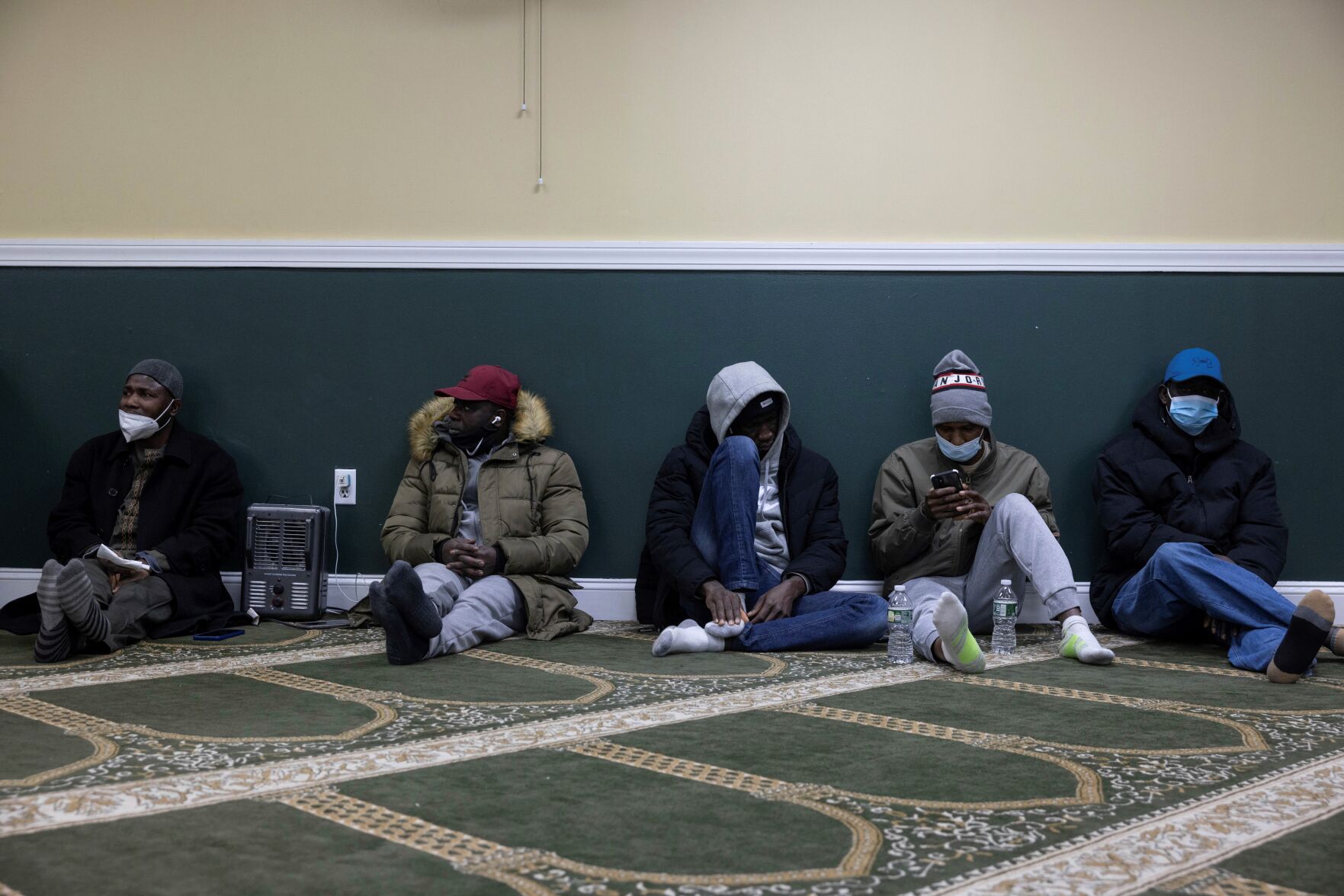 <p>Family members gather and wait for information about missing loved ones at Masjid-Ur-Rahmah near the apartment building which suffered the city's deadliest fire in three decades, in the Bronx borough of New York on Monday, Jan. 10, 2022. </p>