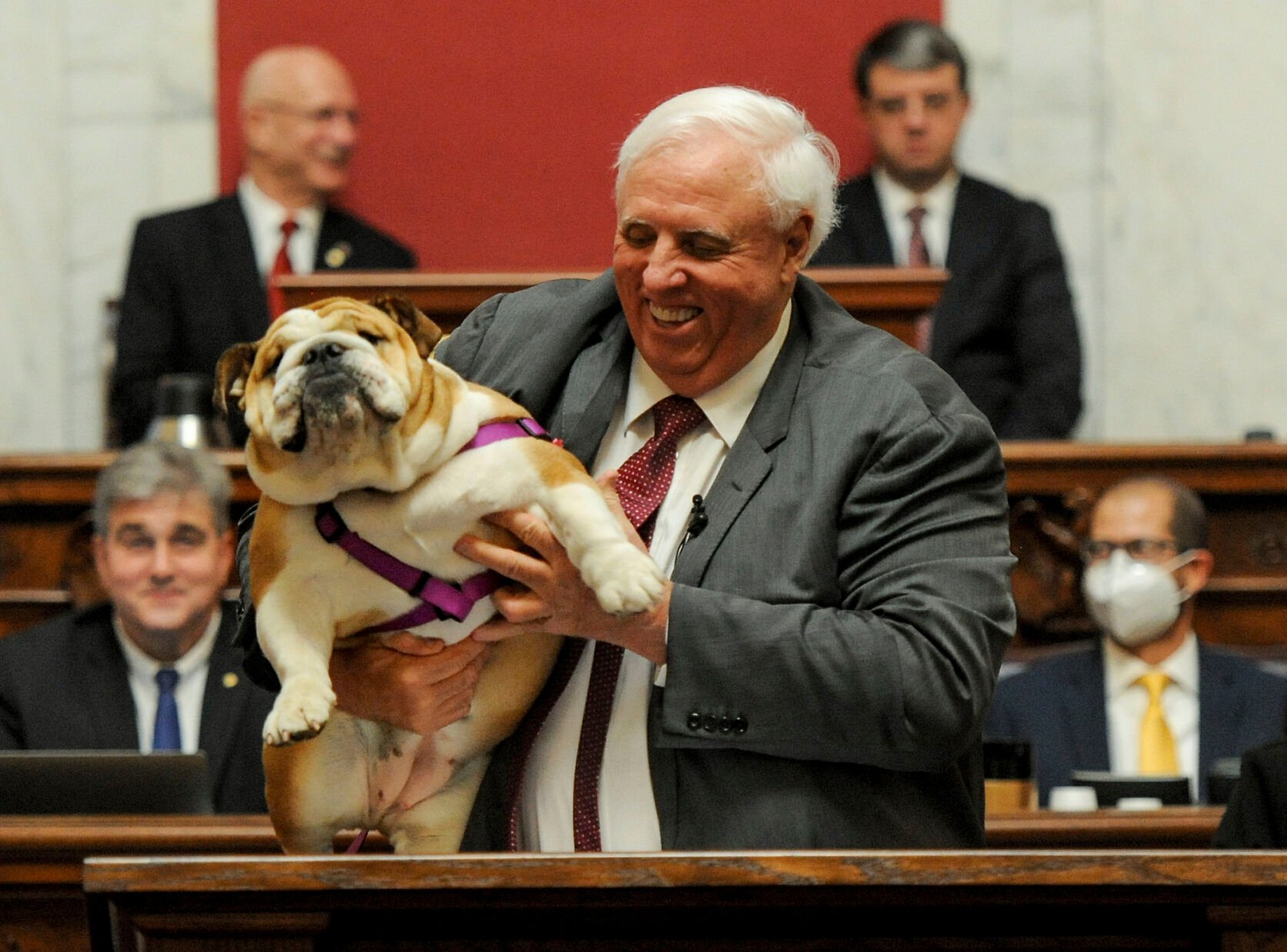 <p>West Virginia Gov. Jim Justice holds up his dog Babydog as he comes to the end of his State of the State speech in the House chambers at the West Virginia State Capitol in Charleston, W.Va., Thursday.</p>