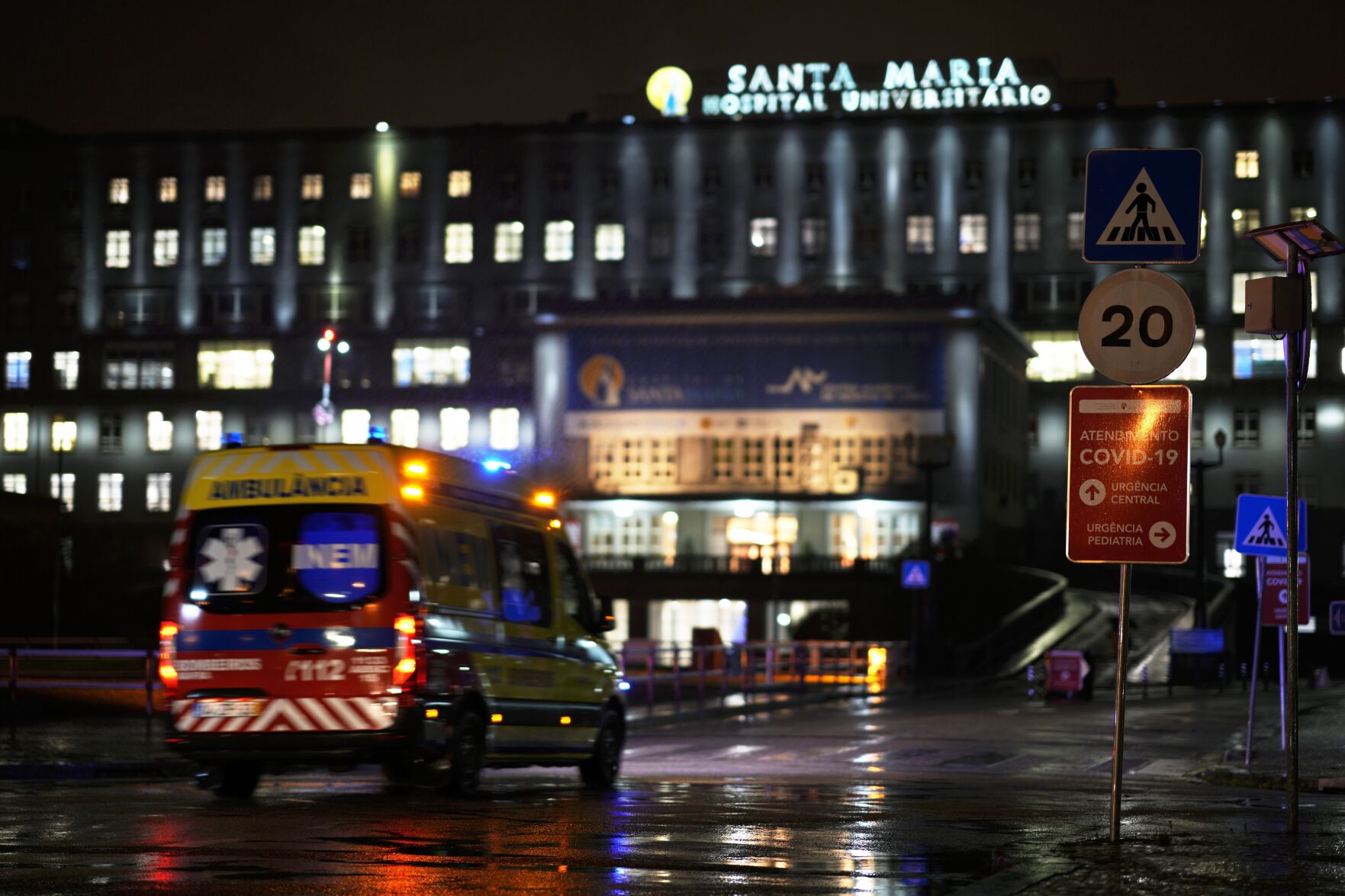 <p>A sign shows directions for the COVID-19 emergency at Lisbon's main Santa Maria hospital, Wednesday, Jan. 5, 2022. The number of officially recorded new daily COVID-19 infections in Portugal hit a new record Wednesday, reaching almost 40,000. (AP Photo/Armando Franca)</p>