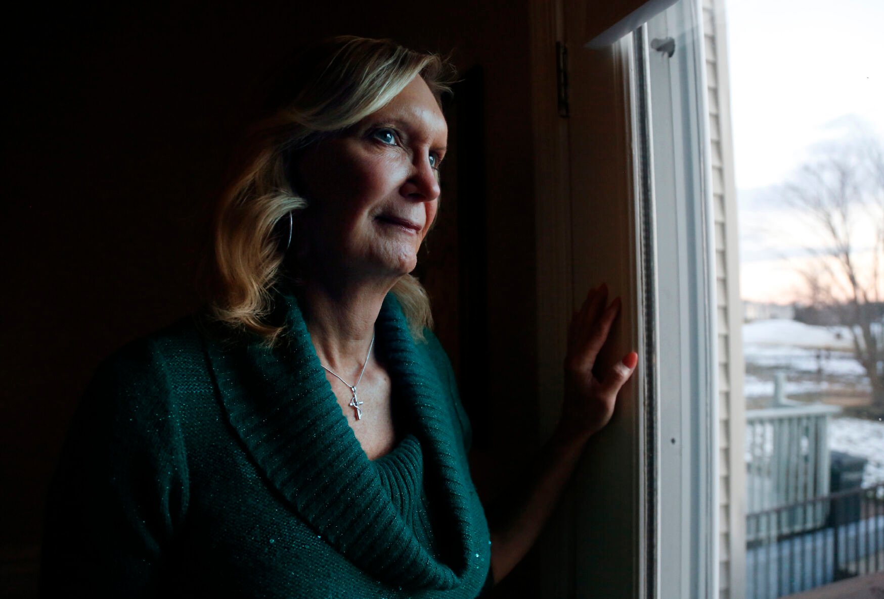 <p>Christine Zuba poses for a portrait at her home in Blackwood, New Jersey, on Monday, Feb. 14, 2022. After coming out as a transgender woman at age 58, Zuba, a lifelong Catholic, was welcomed into Saints Peter and Paul Catholic Church, where she currently serves as a eucharistic minister. </p>