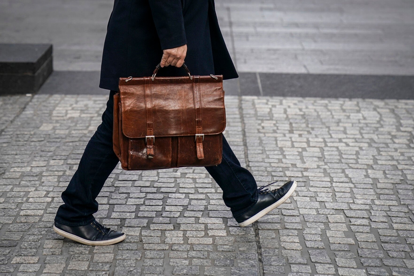 <p>A man carries a briefcase as he walks through the Financial District, January 4, 2019 in New York City.</p>