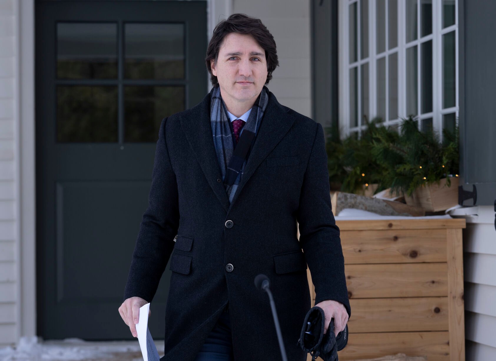 <p>FILE - Canadian Prime Minister Justin Trudeau steps out of a building to speak with the media during his first availability after announcing he has COVID-19 at a location in the National Capital Region, Monday, Jan. 31, 2022. On Friday, Feb. 4, The Associated Press reported on stories circulating online incorrectly claiming Trudeau has been “hiding out” in the U.S. as a convoy of truckers and protesters demonstrate against vaccine mandates in Ottawa. (Adrian Wyld/The Canadian Press via AP, File)</p>