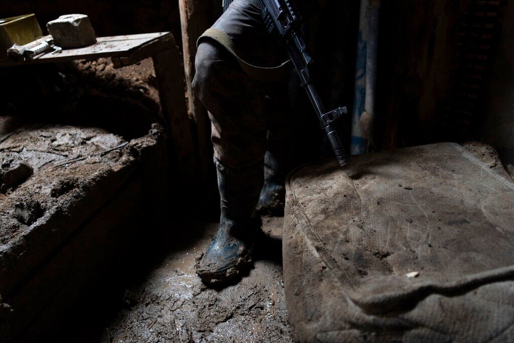 <p>A Ukrainian serviceman stands in a shelter at a position at the line of separation between Ukraine-held territory and rebel-held territory near Zolote, Ukraine, Saturday, Feb. 19, 2022. </p>