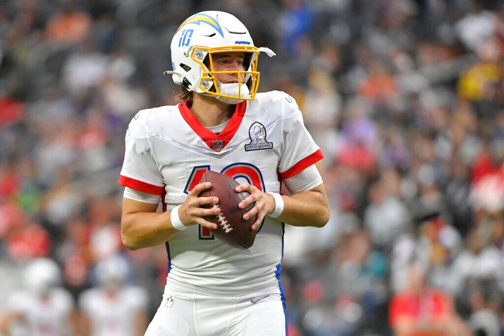 <p>AFC quarterback Justin Herbert (10), of the Los Angeles Chargers, looks to pass against the NFC during the first half of the Pro Bowl NFL football game, Sunday, Feb. 6, 2022, in Las Vegas. (AP Photo/David Becker)</p>