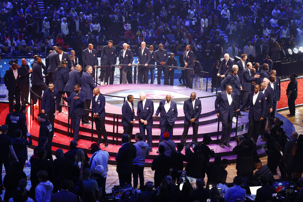 <p>75 of the leagues greatest players gather on a stage during halftime at of the NBA All-Star basketball game, Sunday, Feb. 20, 2022, in Cleveland. (AP Photo/Ron Schwane)</p>