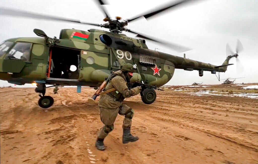 <p>FILE - In this frame from video provided by the Russian Defense Ministry Press Service on Feb. 19, 2022, a Russian marine runs during the Union Courage-2022 Russia-Belarus military drills at the Obuz-Lesnovsky training ground in Belarus. </p>