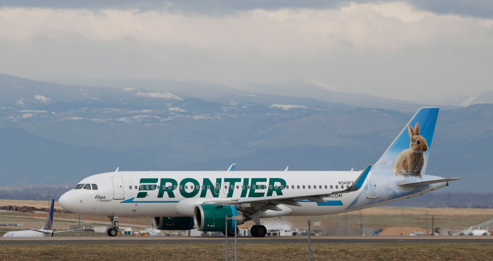 <p>FILE - A Frontier Airlines jetliner taxis to a runway to take off from Denver International Airport Thursday, April 23, 2020, in Denver. Frontier Airlines' parent company is buying Spirit Airlines in a .9 billion cash-and-stock deal that will allow the combined airline to be more competitive against its larger rivals. (AP Photo/David Zalubowski, File)</p>