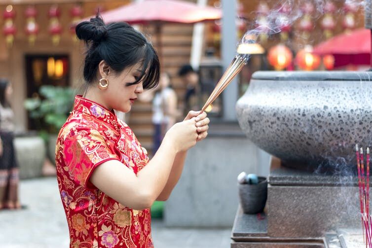 <p>A Chinese woman offers incense at a temple. <a class="source" href="https://www.gettyimages.com/detail/photo/chinese-new-year-is-the-most-important-traditional-royalty-free-image/1281307813?adppopup=true">Papakon Mitsanit/Moment via Getty Images</a></p>