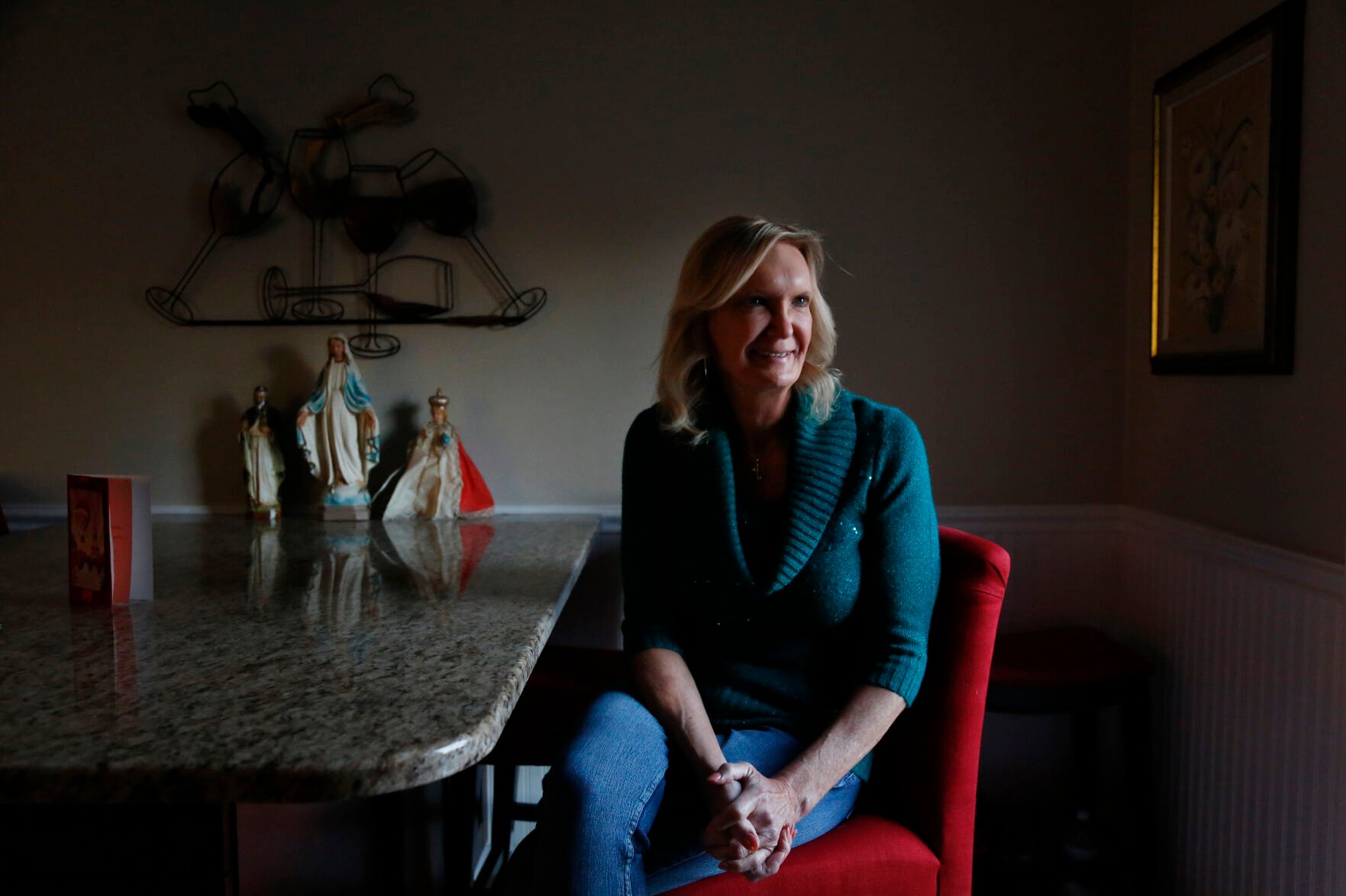 <p>Christine Zuba poses for a portrait in her kitchen in Blackwood, New Jersey, on Monday, Feb. 14, 2022. After coming out as a transgender woman at age 58, Zuba, a lifelong Catholic, was welcomed into Saints Peter and Paul Catholic Church, where she currently serves as a eucharistic minister. </p>