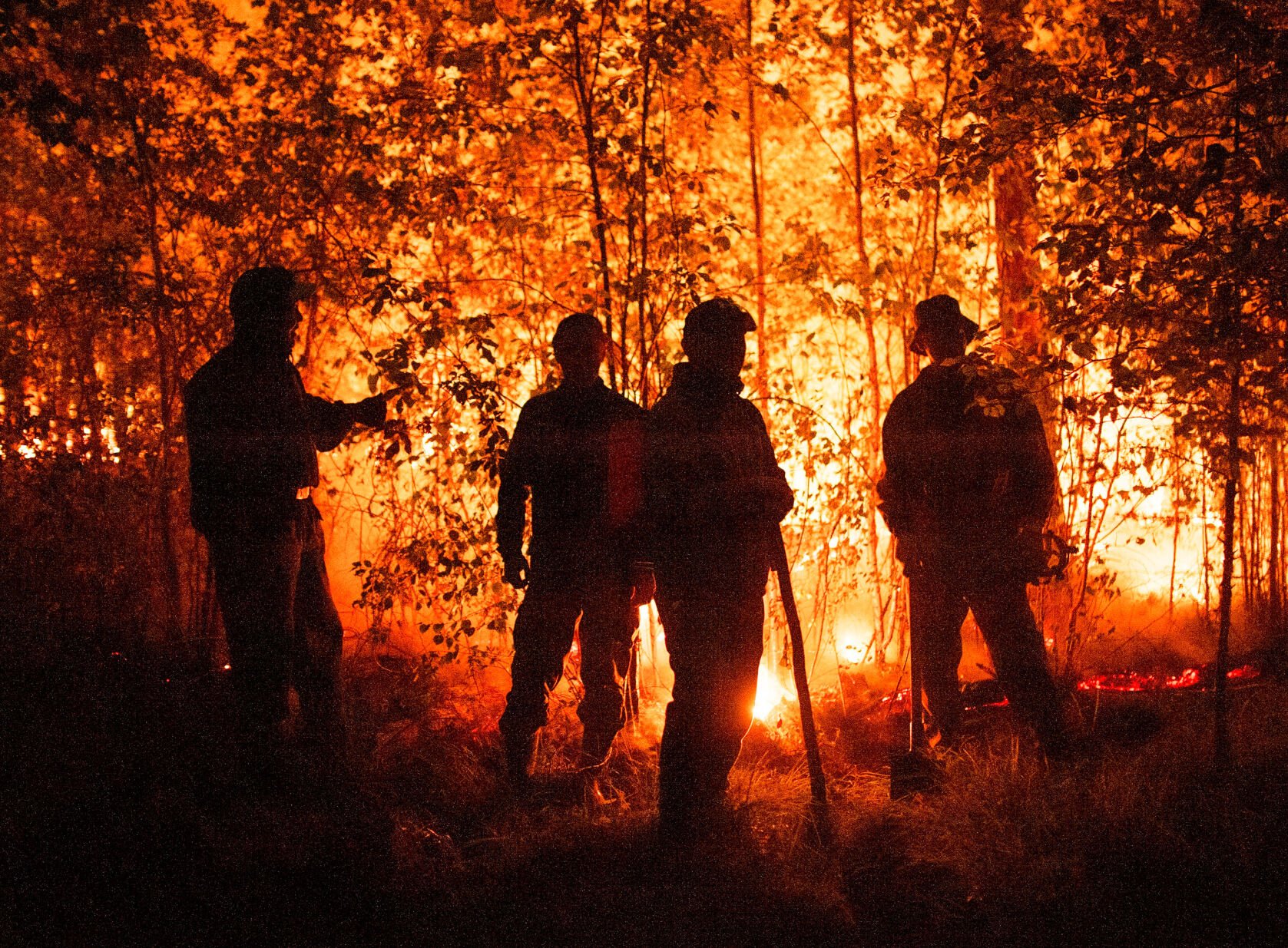 <p>Firefighters work at the scene of a forest fire west of Yakutsk, Russia, on Aug. 5, 2021.</p>