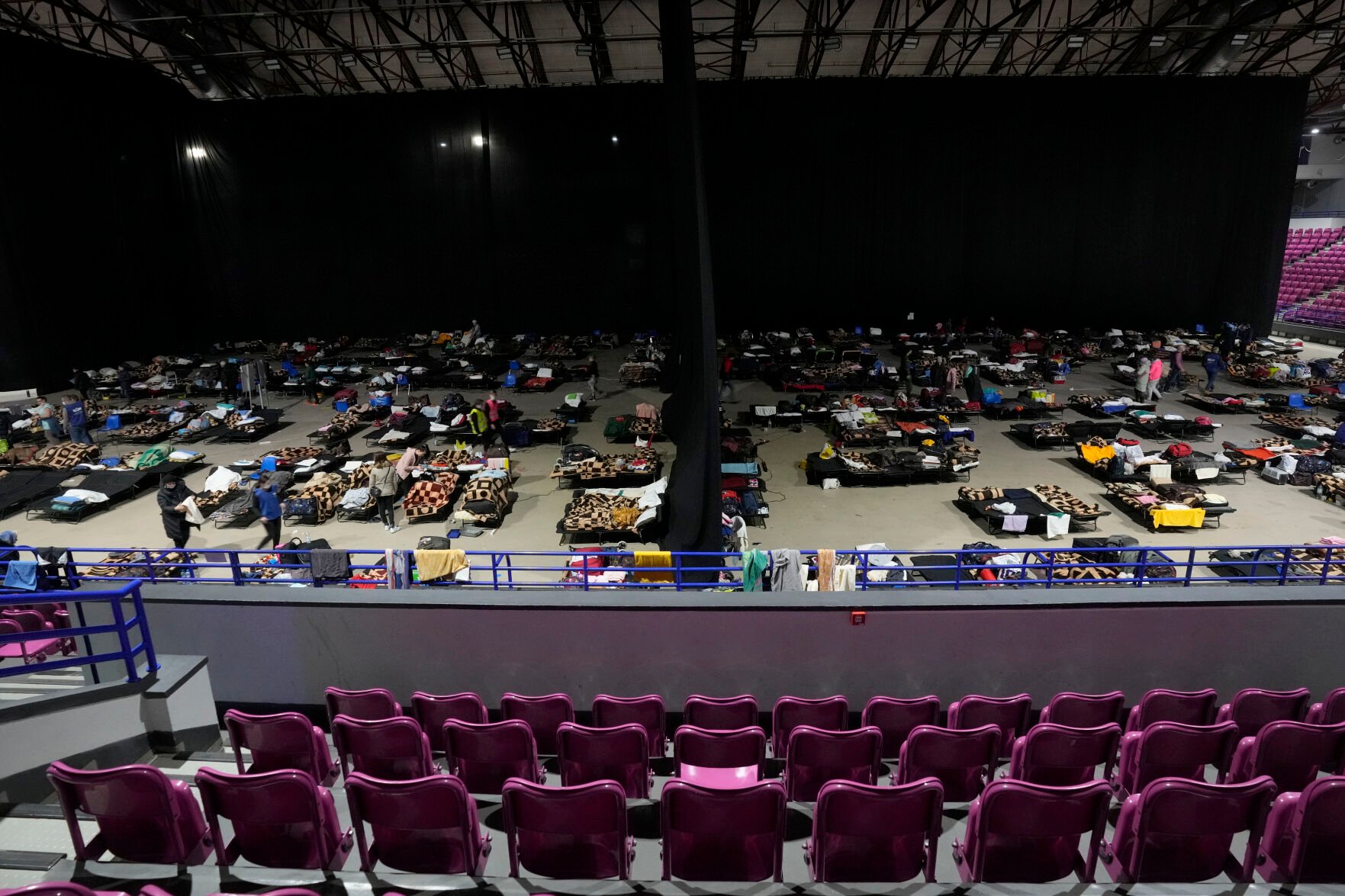 <p>Refugees from Ukraine rest at a sports hall turned refugee center in Warsaw, Poland, on Friday.</p>