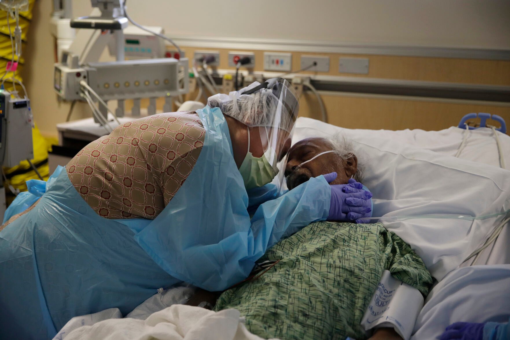 <p>Romelia Navarro, 64, weeps while hugging her husband, Antonio, in his final moments in a COVID-19 unit at St. Jude Medical Center in Fullerton, Calif., July 31, 2020. </p>
